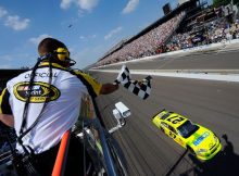 Paul Menard, driver of the No. 27 NIBCO/Menards Chevrolet, takes the checkered flag as he crosses the finish line to win the NASCAR Sprint Cup Series Brickyard 400 at Indianapolis Motor Speedway on July 31 in Indianapolis, Ind. Credit: Jason Smith/Getty Images for NASCAR